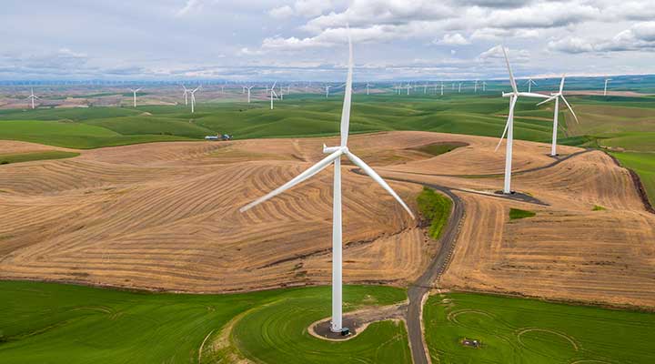land-based-research-capability-controls A photo of a green and brown field of multiple wind turbines in the foreground and background.